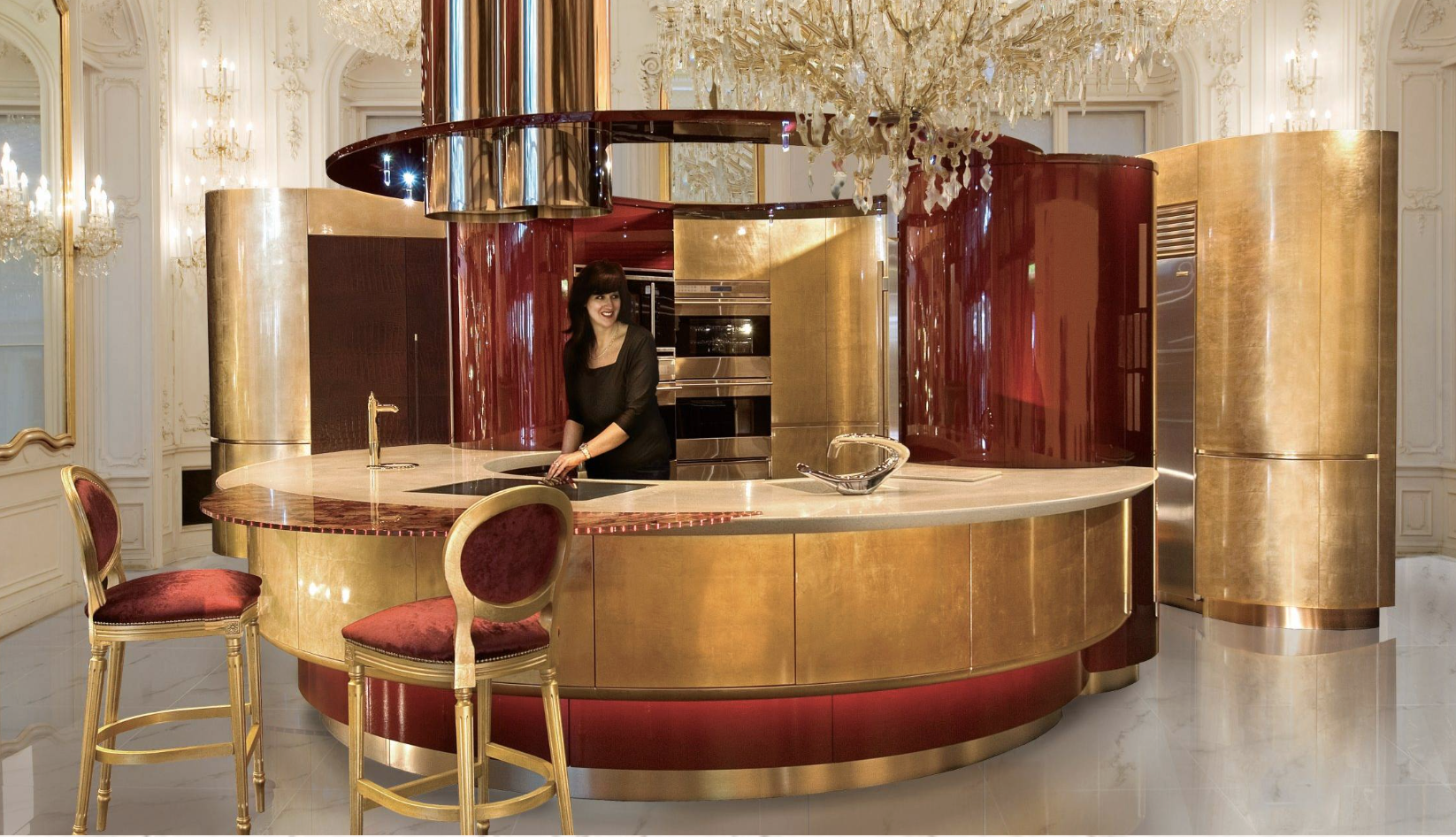 Modern kitchen with glossy dark red and gold curved cabinets and countertop